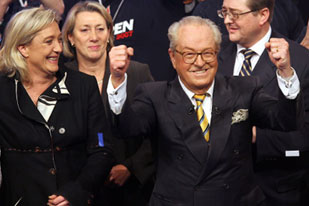 France's then-National Front leader Jean-Marie Le Pen is flanked by his daughter, Marine Le Pen, left, at a convention in February 2007 [AFP/ Philippe Huguen]