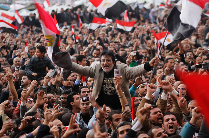 Egyptians wave flags in Tahrir Square