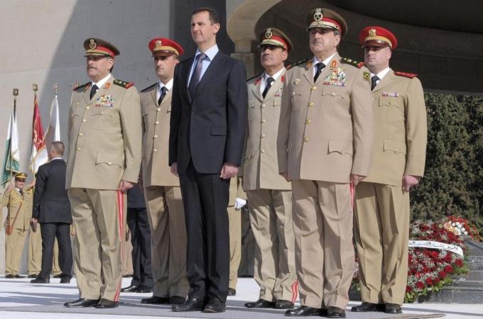 File handout photo of Syria''s President Assad standing with Fahad Jassim al-Freij and Daoud Rajha in Damascus