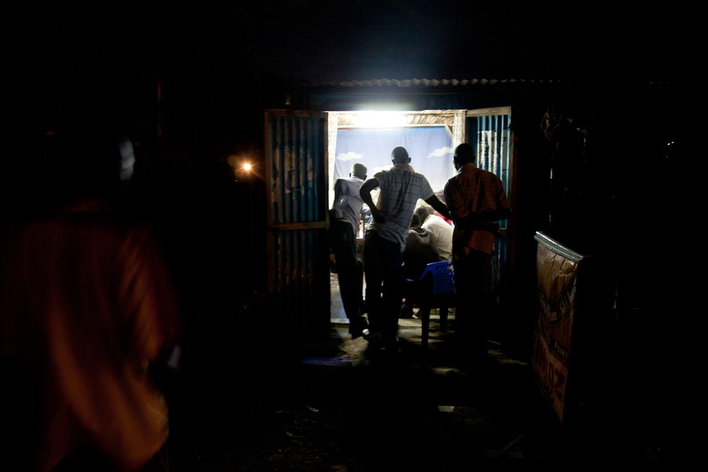 Kisumu residents watch the presidential debate in a barbershop. Kenya(***)s third largest city, the stronghold of candidate 
Raila Odinga, erupted in violence after it was announced Odinga had lost the 2007 vote.