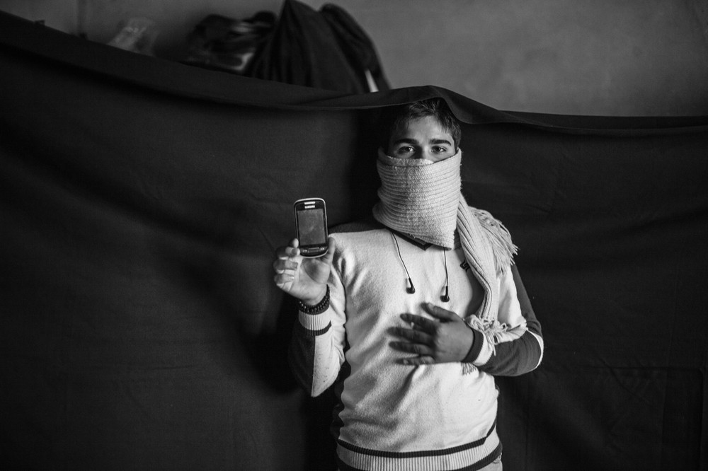 Yusuf and his family fled their home several months before this photograph was taken. 

The most important thing he was able to bring from Syria is the mobile phone that he holds in this photograph.  "With this, I(***)m able to call my father. We(***)re close enough to Syria here that I can catch  signal from the Syrian towers sometimes."  The phone also holds photographs of family members who are still in Syria, which he is able to keep with him at all times.