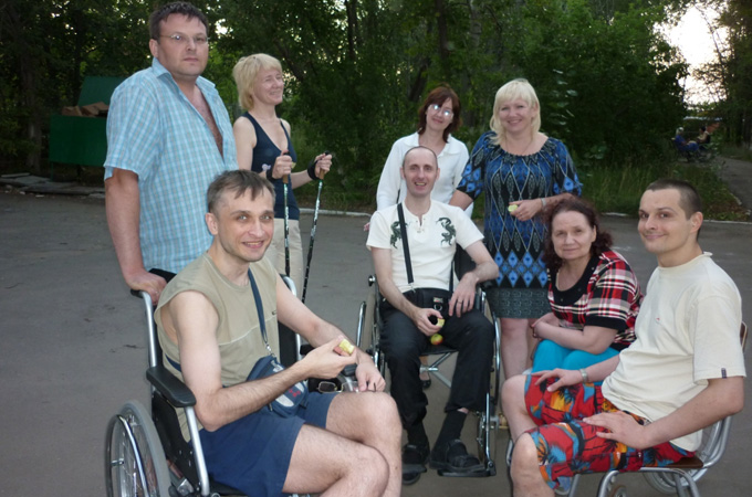 Pavel, left, uses a wheelchair to move around and delegates tasks such as cooking and cleaning to family members 
[Al Jazeera]