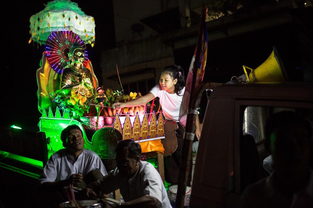 <p class="MsoNormal"><span style="font-size: 10pt; line-height: 115%; font-family: Arial, sans-serif; background-position: initial initial; background-repeat: initial initial;">A young girl places an incense stick in the base of a Buddha statue located in the bed of a pickup truck during the Thadingyut lighting festival in downtown Yangon, Myanmar.</span></p>