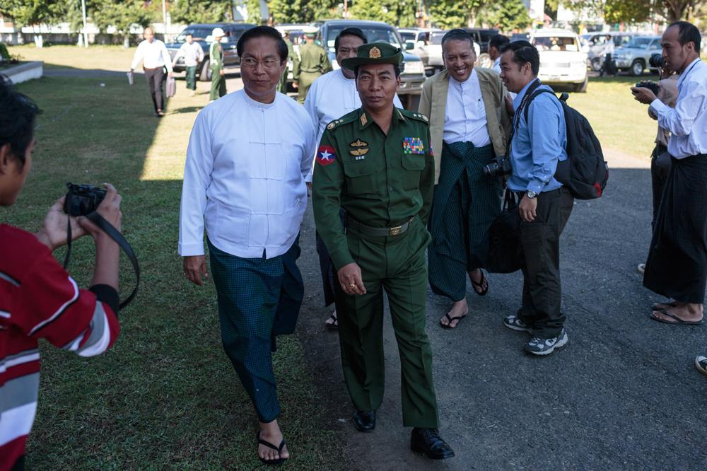 <p>Lieutenant General Myint Soe of the Myanmar army is ushered into the first day of meetings between the military and rebel groups over the possible implementation of a ceasefire agreement in Myitkyina, Myanmar on November 4.</p>
