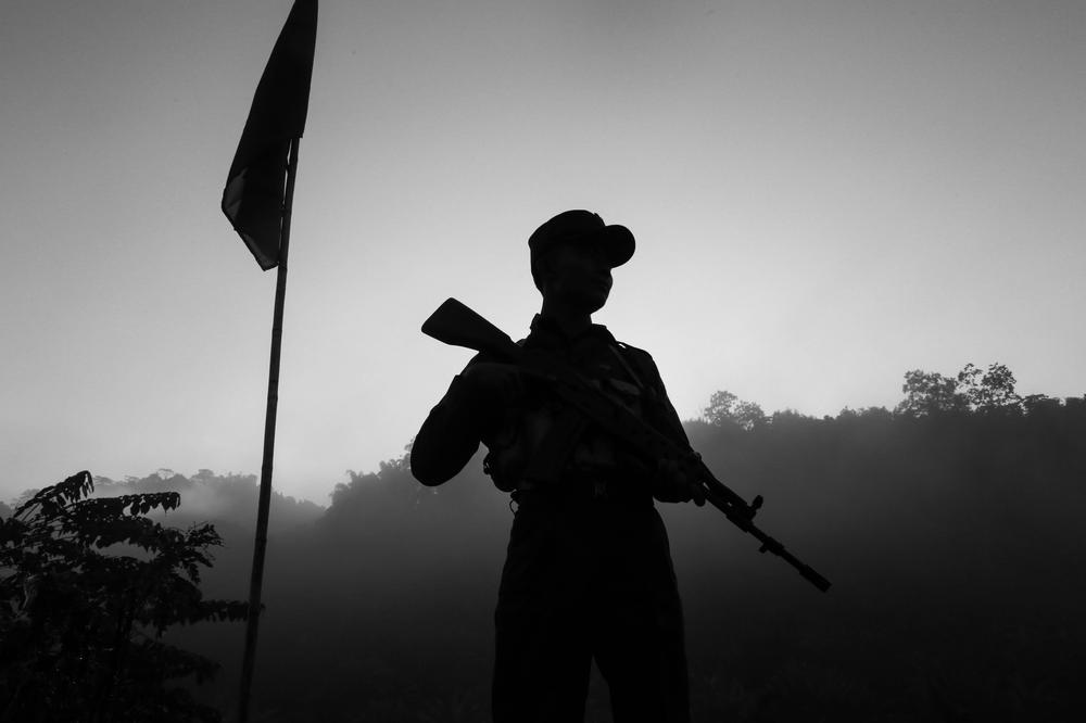 <p>A soldier stands guard on one side of the mountain while the Myanmar military is deployed on the other side.</p>