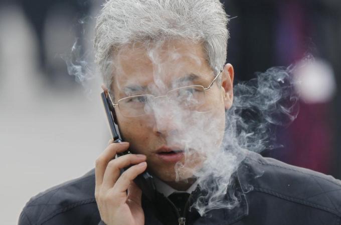China has banned its officials from smoking in public to set an example to the rest of the country [AP]