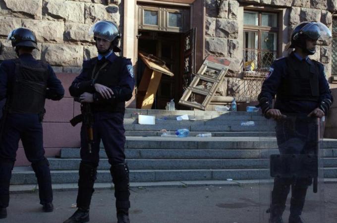 Policemen stand guard outside the burned trade union building in the southern Ukrainian city of Odessa [AFP]