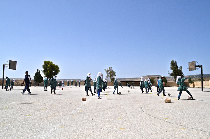 Coaches say that negative attitudes towards girls playing football have eased [Elizabeth Whitman/Al Jazeera]