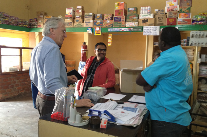 Simon Berry and Rohit Ramchandani speak to a shop owner about their life-saving product in Katete, Zambia [SIMON BERRY]