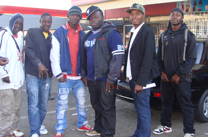Nigerians pose for a group photo in a Johannesburg, South Africa street [Tsidi Bishop/Al Jazeera]