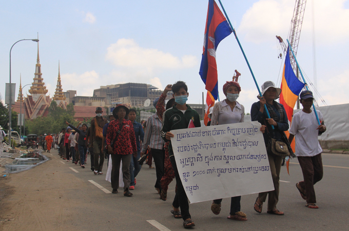 Protesters march through Phnom Penh after staging a demonstration outside the Australian embassy against the refugee deal [Daniel Pye/Al Jazeera]