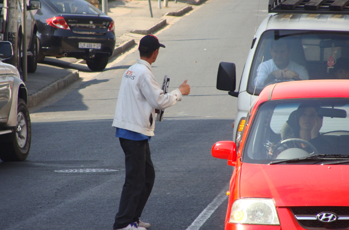 A beggar in the streets of Johannesburg, South Africa, asks for alms [Tsidi Bishop/Al Jazeera]