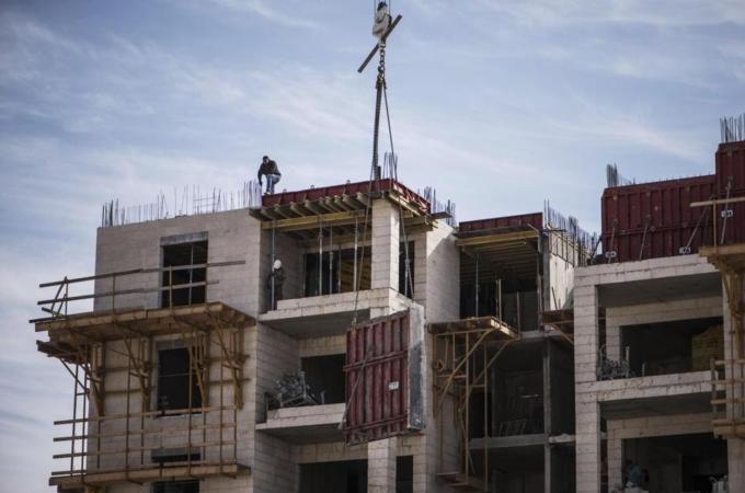 Palestinian workers seen at the construction site of Israeli settlement 'Har-Homa' in Jerusalem [Getty]