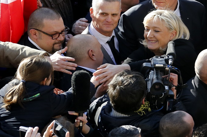 Marine Le Pen greets people as she attends a rally to honour the victims of the Paris attacks [EPA]