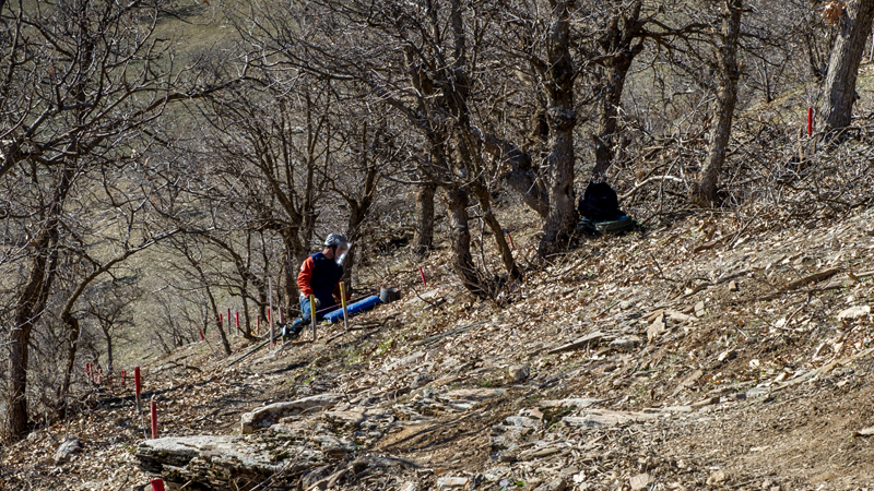 A de-miner screens the ground for possible mine contamination [Martin Bader/Al Jazeera]