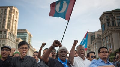 Hundreds of Anwar supporters, surrounded by dozens of police, gathered outside the court [AFP]