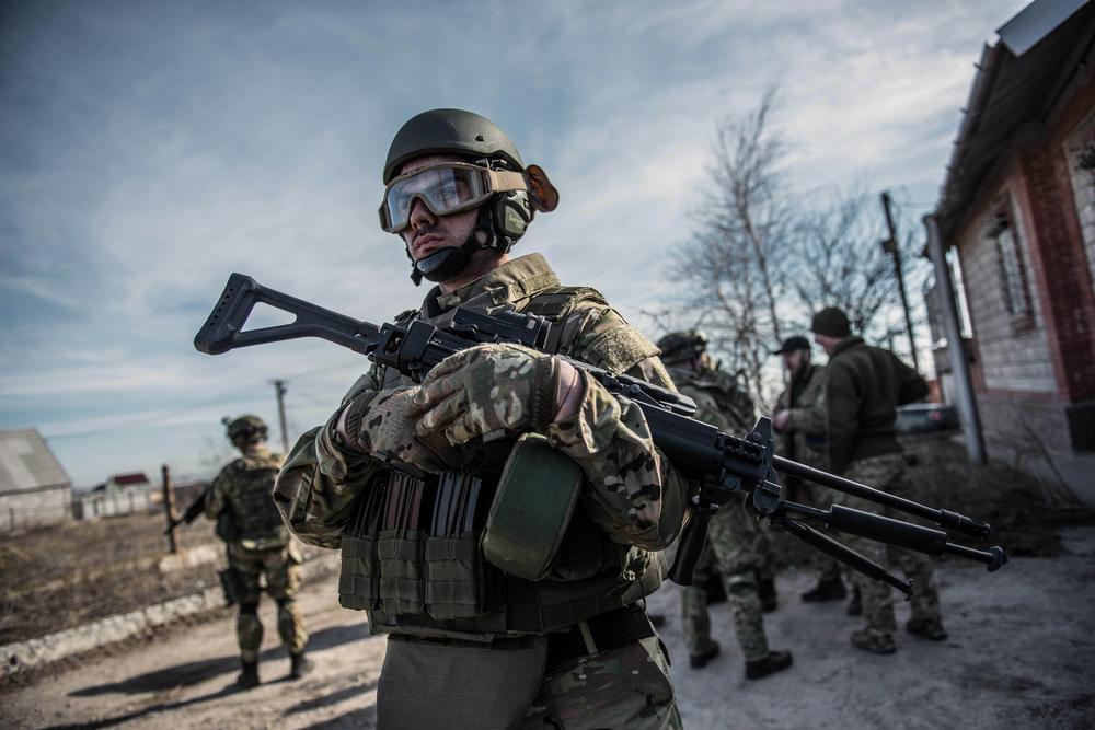 An Azov battalion fighter stands guard at a military base in Berdianskwe.