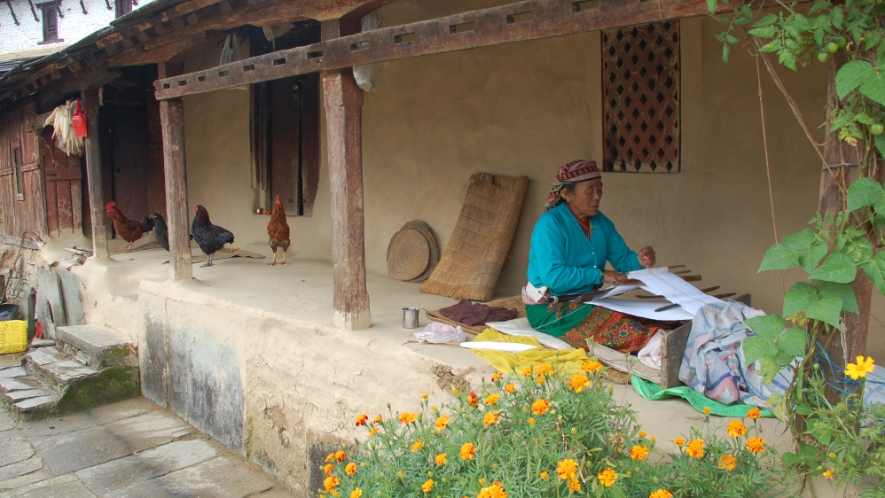 A Gurung woman weaves on the porch of her house in the village of Ghandruk, Nepal [AP]