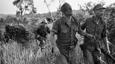 A US Marine was wounded as he fought against the Vietcong from inside an amphibious tank, 1965 [AP]