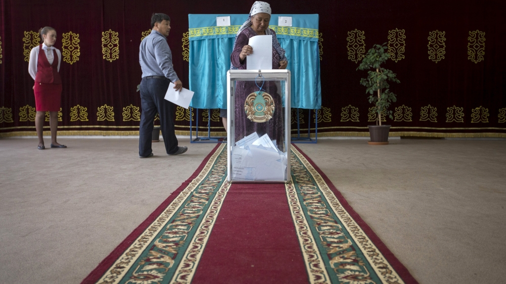 A woman casts her ballot during a snap presidential election in the village of Tuzdybastau, Kazakhstan