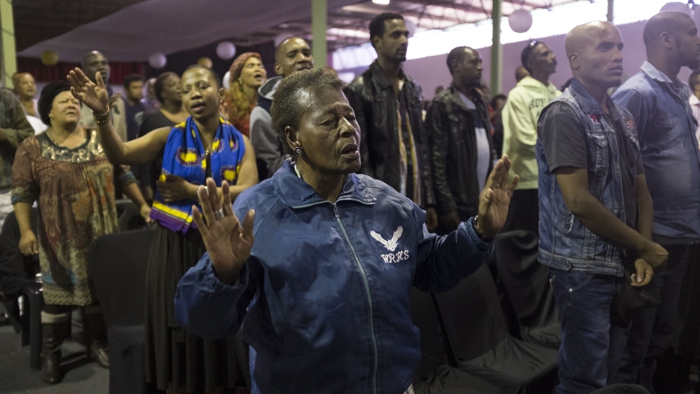 People pray for peace and friendship in the wake of violence against foreign nationals occurring in some parts of the country in Johannesburg [Getty]
