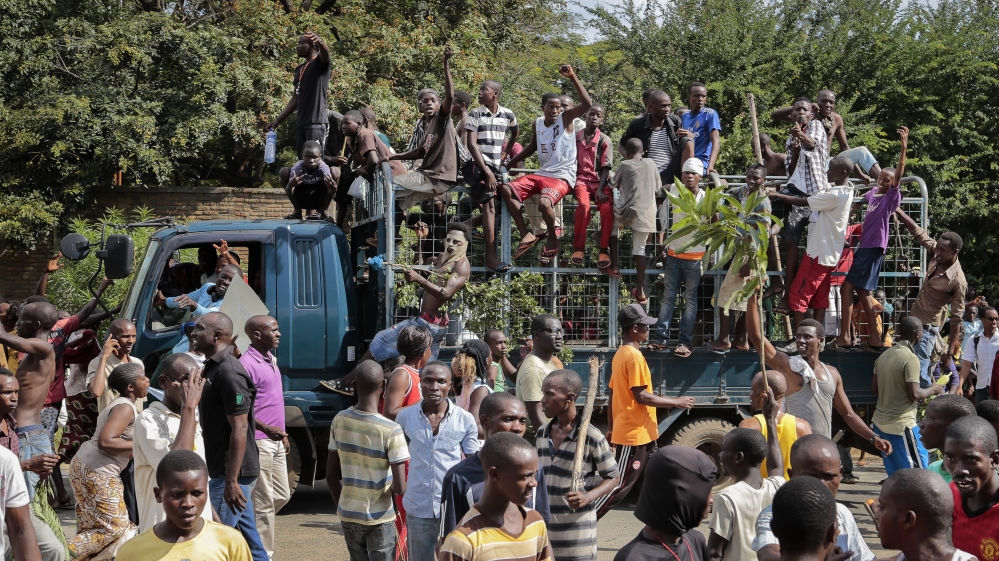 Demonstrators celebrate what they perceive to be an attempted military coup d''etat in the capital Bujumbura, Burundi [AP]