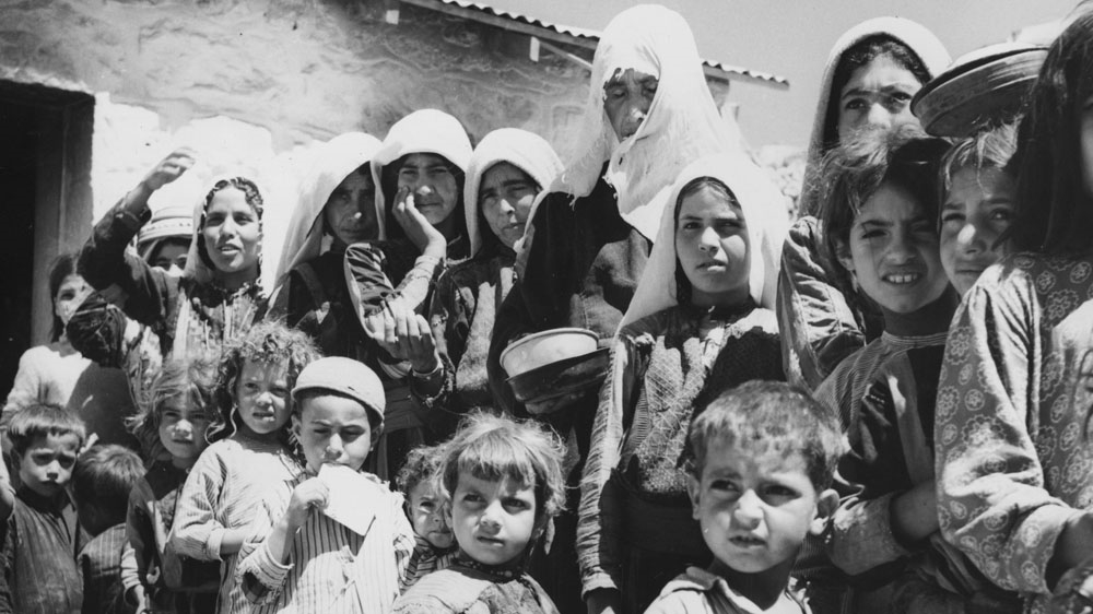 Palestinian refugees form a queue by the food tent in their camp in Amman, Jordan, circa 1955 [Getty Images]