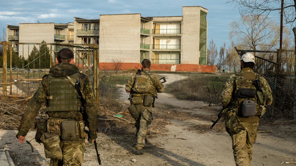 Garrett leads other European fighters towards the front line in Shyrokyne [Christopher Allen/Al Jazeera] 