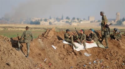 YPG fighters gather at the eastern entrance to the town of Tal Abyad [REUTERS]