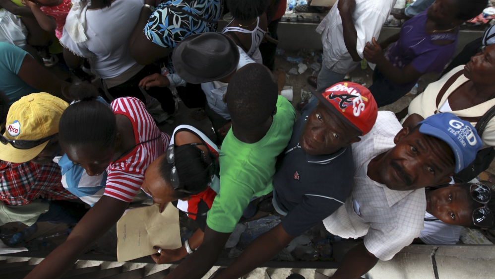 Haitians stand outside the Ministry of Interior and Police while waiting to register in the so-called "regularization" program in Santo Domingo