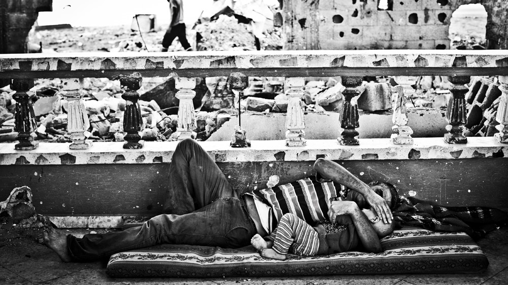 Abdel Abu Ouda, Shady's brother, and his son rest in the living room of their house in Beit Hanoun [Virginie Nguyen Hoang/Hanslucas/Collectif Huma] 