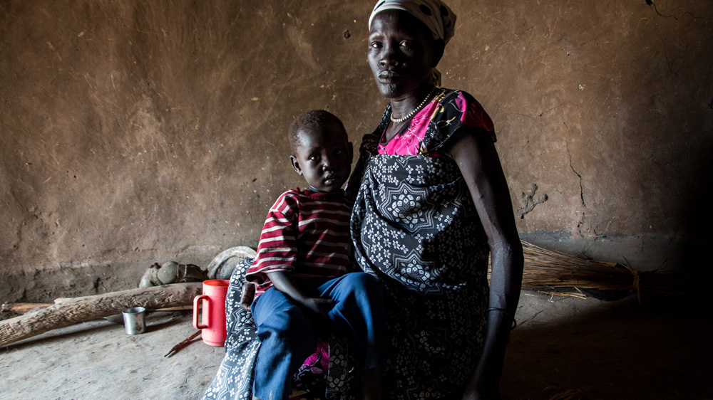 Nyaway Gatluok is seven months pregnant and arrived in Fangak two weeks ago after escaping Unity State, where she lost track of her husband and one daughter [Ashley Hamer/Al Jazeera]
