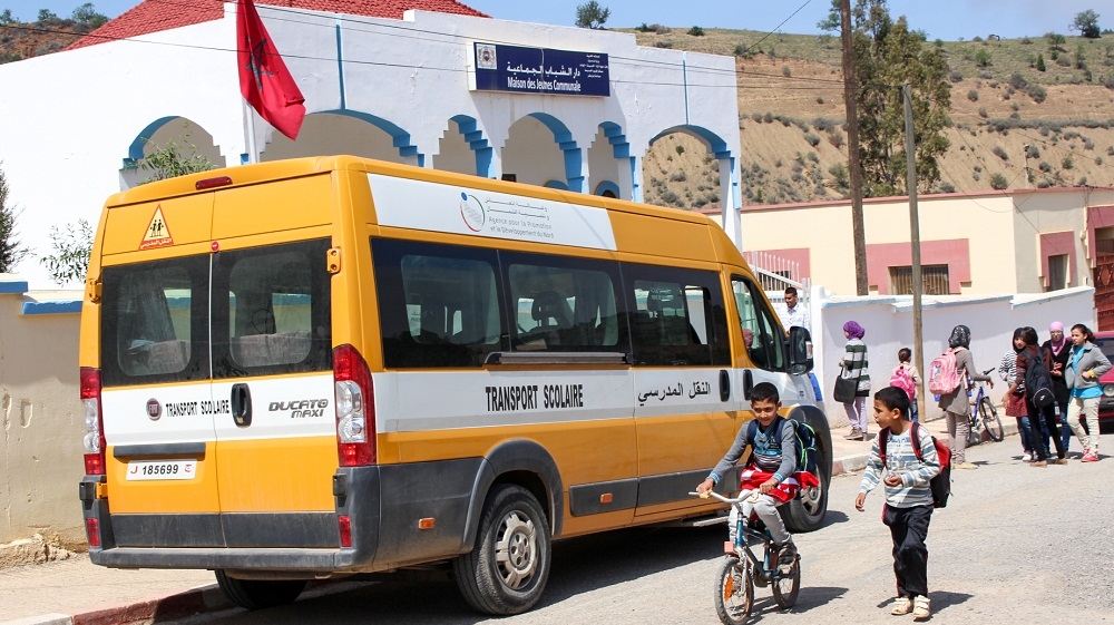 Two transportation vehicles service middle school students in Tamassint, but are only available for a monthly fee [Julia Barstow/Al Jazeera]