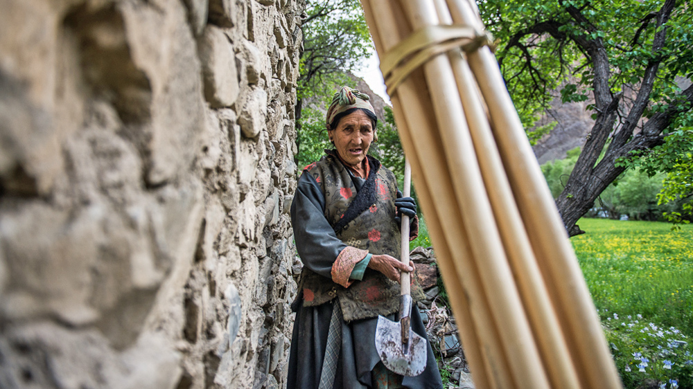 Tenzing Dolkar, the village head of Tar, pointed to the spot where a snow leopard killed one of her goats. [Felix Gaedtke/NowHere Media /Al Jazeera]