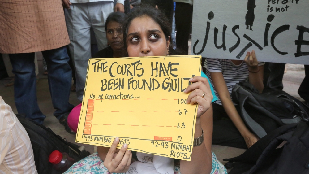 Indian social activists from varous organiszatons hold placards during a protest against capital punihsment