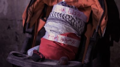 In tribute to the 18-month-old child who died in the Duma arson attack, a wrapped baby bundle still sits inside the home [Ash Gallagher/Al Jazeera]