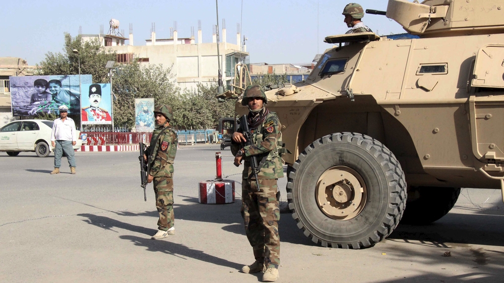 Afghan soldiers keep watch during a battle with the Taliban in Kunduz Province on Monday [Reuters]
