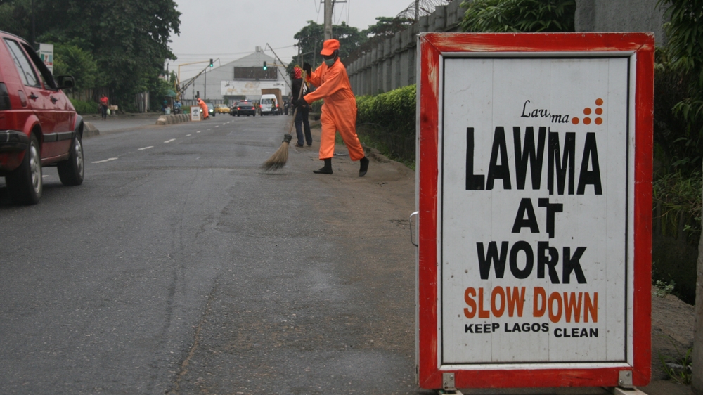 The dust and sand can cause respiratory problems and eye infections for the street sweepers [Abiodun Omotosho/Al Jazeera]