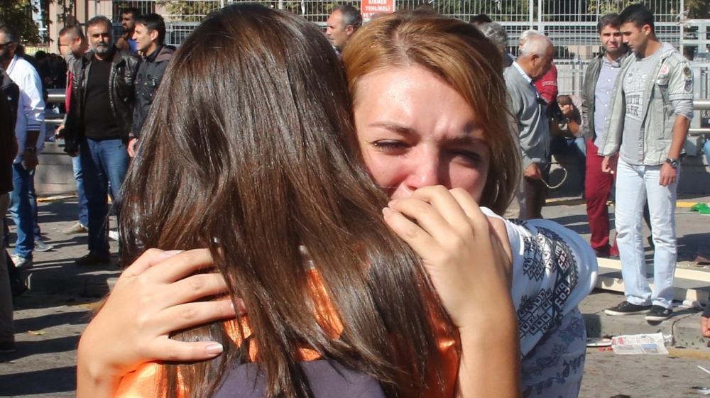 People react on the multiple explosions that killed many demonstrators in Ankara [EPA]