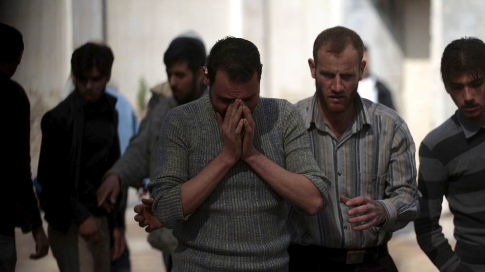 A man reacts as he mourns the death of his relative after missiles were fired by Syrian government forces on a busy marketplace in the Douma neighborhood of Damascus, Syria