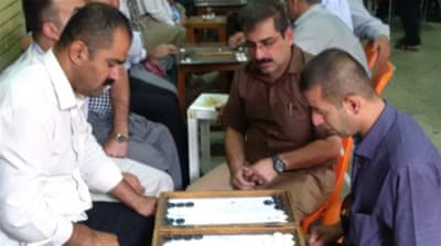 Men play backgammon at Chaikhana Shaab, in the northern Iraqi city of Sulaimania [Tanya Goudsouzian/Al Jazeera]