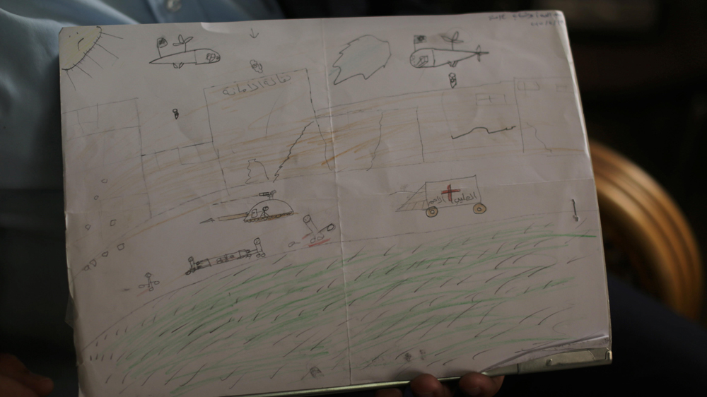 This scene of war and destruction was drawn by a child undergoing counselling for PTSD at the Khan Younis Community Mental Health Programme [Lara Aburamadan/Al Jazeera]