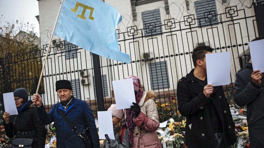 Crimean Tatars and Ukrainian activists protest in front of the Russian embassy in Kiev
