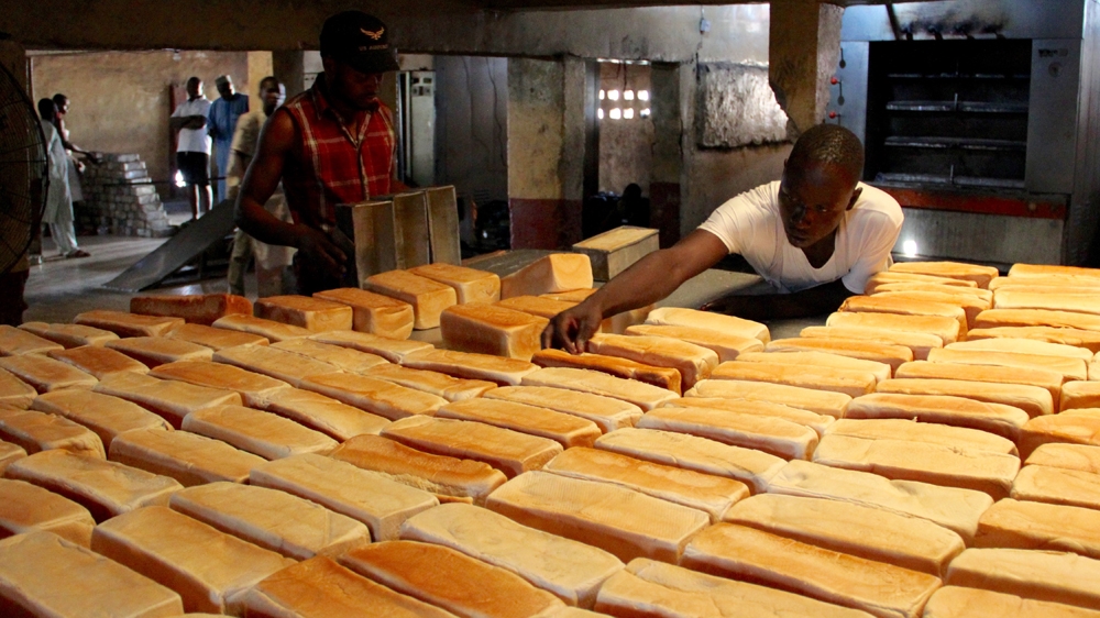 Mohammed Ibrahim, right, one of Aliyu's colleagues at the bakery, says he still misses Aliyu's jokes [Femke van Zeijl/Al Jazeera]