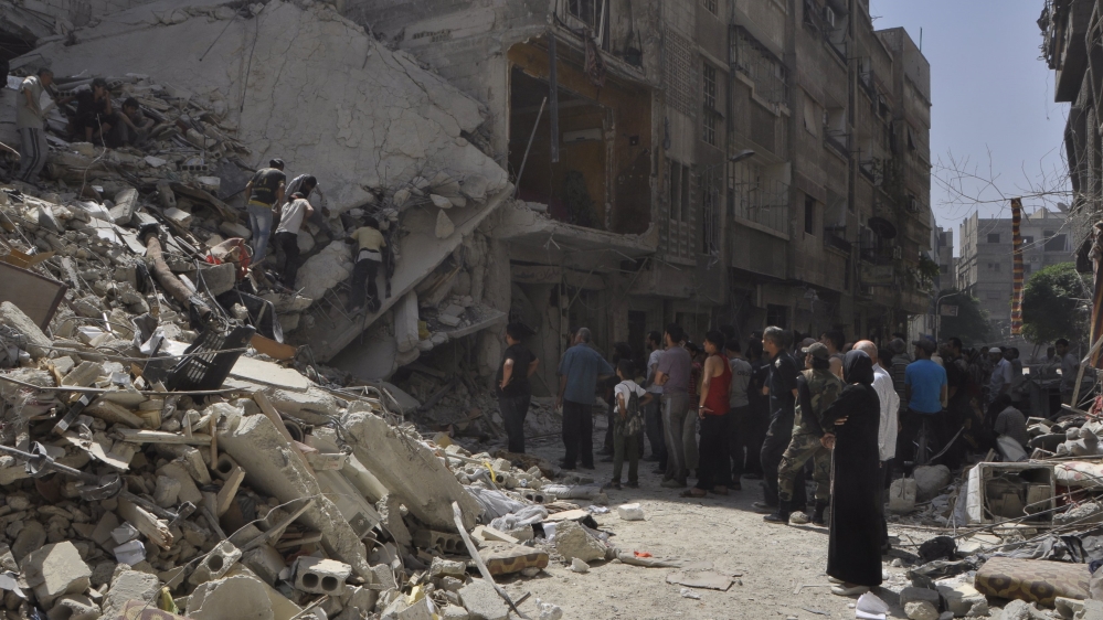 Yarmouk residents inspect a site hit by what activists said were barrel bombs thrown by Assad forces on May 26, 2015. [File: Moayad Zaghmout/Reuters]