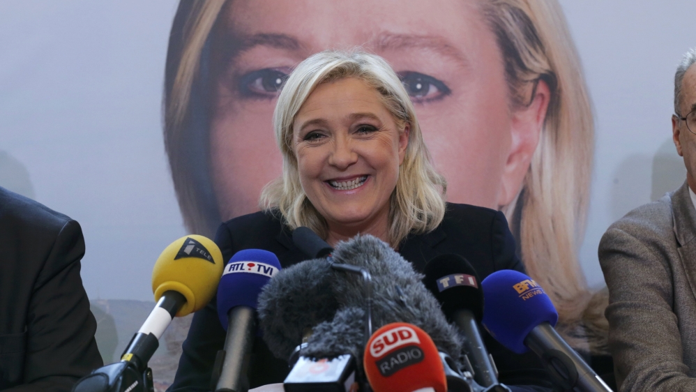 People wearing protective masks ride bicycles in the morning on an extremely polluted day in Beijing