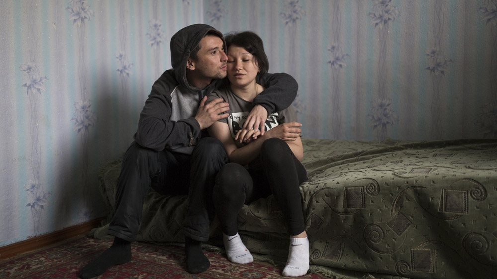 Twenty-eight-year-old Renat and 20-year-old Regina would like to get married, but have not been able to save enough money to do so, even though Renat has worked in, mostly illegal, mines for the past eight years. [Janos Chiala and Tali Mayer/Al Jazeera]  