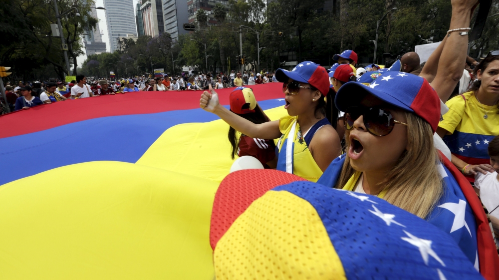 File photo of people carrying a giant Venezuelan flag during a protest in Mexico City of Venezuelan citizens residing in Mexico