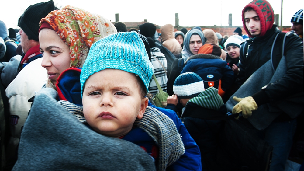 Parents try to keep their children warm, but those who run the transit camps say they simply aren't prepared for winter [Mona van den Berg/Al Jazeera]