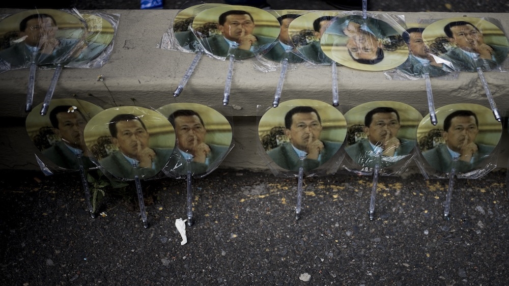 Fans featuring the face of Hugo Chavez, the late Venezuelan leader, for sale during the ruling party's closing campaign rally in Caracas [Alejandro Cegarra/Al Jazeera]